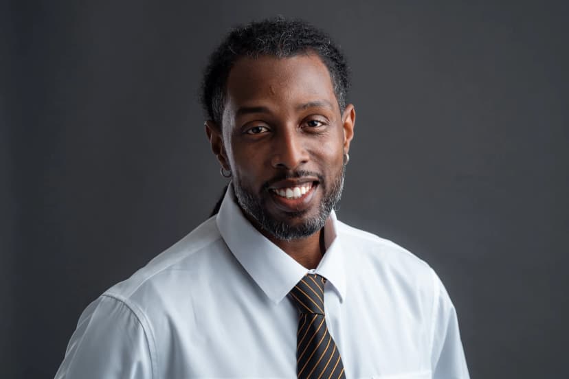 Professional corporate headshot with clean lighting and neutral background
