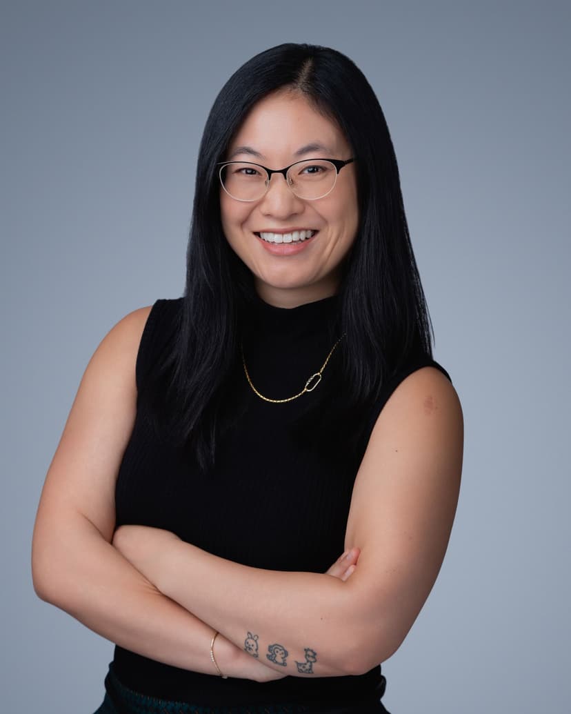 Professional woman with glasses in polished corporate headshot